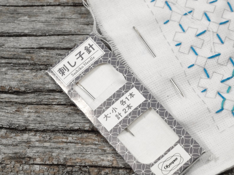 May include: A package of two sashiko needles, labeled "Sashiko Needle" and "大・小 各1本 計2本". The needles are silver and are packaged on a white background with a gray and white pattern.