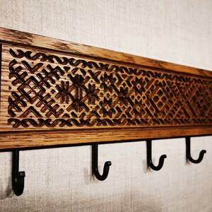 Unique wooden carved etno-patterned coat rack with five hooks