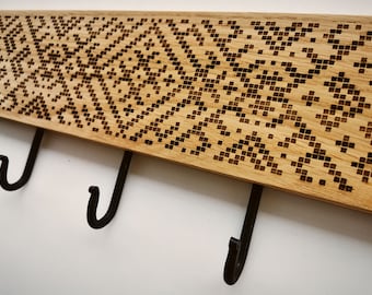 Wall mounted wooden coat rack with archaic ethnic pattern