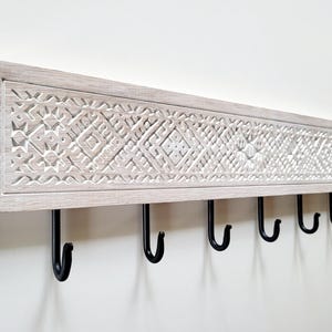 Artistic washed white wall mount coat rack with ethnic design Etno