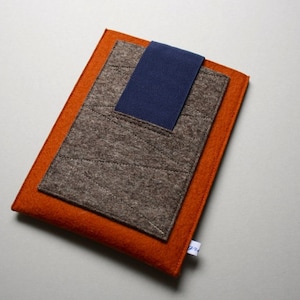 May include: A brown felt laptop sleeve with a blue felt accent and an orange felt outer layer.