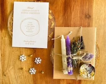 May include: A brown paper envelope with a white and purple candle, a small bundle of dried herbs, a black incense stick, and a small jar of crystals. The envelope is tied with twine and has a handwritten note that reads "Ritual: Cerrar Ciclos y Nuevos Comienzos" and "Cerré mis ojos a viejos finales y los abri a nuevos comienzos".