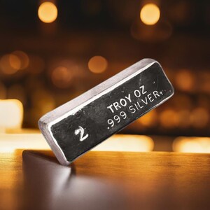 May include: A silver bar with the text "2 TROY OZ .999 SILVER" on it.