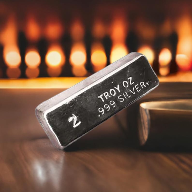 May include: A silver bar with the text "2 TROY OZ .999 SILVER" on it.