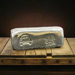 May include: A silver bar with a car silhouette and the text "ONE OZ 999.9S" on it.