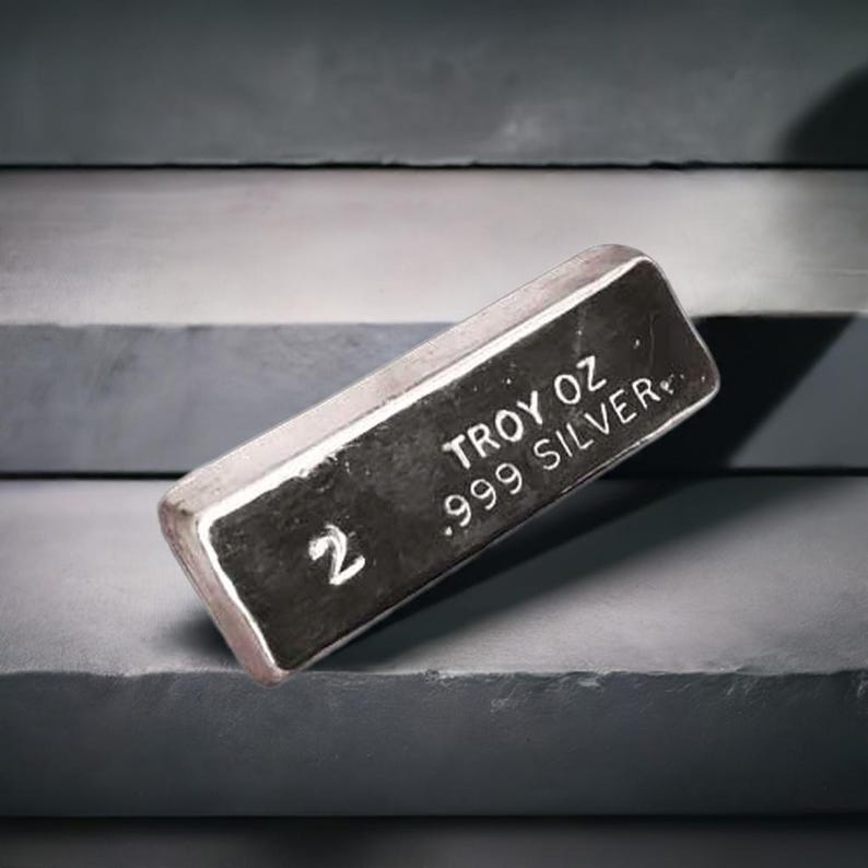May include: A silver bar with the text "2 TROY OZ .999 SILVER" on it.