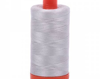 May include: A spool of silver gray thread with an orange plastic bobbin.