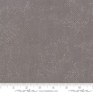 May include: A gray fabric with a white speckled pattern. The fabric has a subtle texture and a slightly faded look.