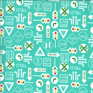 May include: A turquoise fabric with a repeating pattern of various road signs, including stop signs, give way signs, one-way signs, keep right signs, railway crossing signs, and traffic lights. The signs are white with black lettering and green borders.