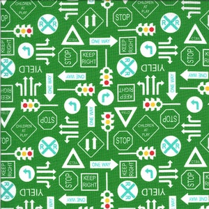 May include: A green fabric with a repeating pattern of white traffic signs and symbols. The signs include "Stop", "Yield", "One Way", "Keep Right", "Children at Play", and "RR". There are also traffic lights and arrows.