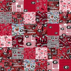 May include: A red, white, and black patchwork fabric featuring the University of Georgia Bulldogs logo, the words "Georgia" and "Dawgs", and the phrase "Hunker Down".