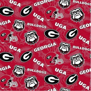 May include: Red fabric with a repeating pattern of the University of Georgia logo, the words "Georgia", "UGA", and "Bulldogs", and a bulldog mascot.