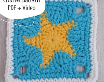 May include: A square crochet pattern featuring a yellow starburst design on a blue background, framed by a white border. The text "Crochet pattern PDF + Video" is in the upper left corner. This handmade item is perfect for crafting projects.