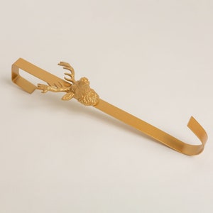 May include: Gold metal stocking holder with a deer head design.