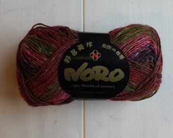 May include: A skein of Noro yarn in a multi-colored pattern of red, green, and brown. The label reads "Noro the World of Nature."