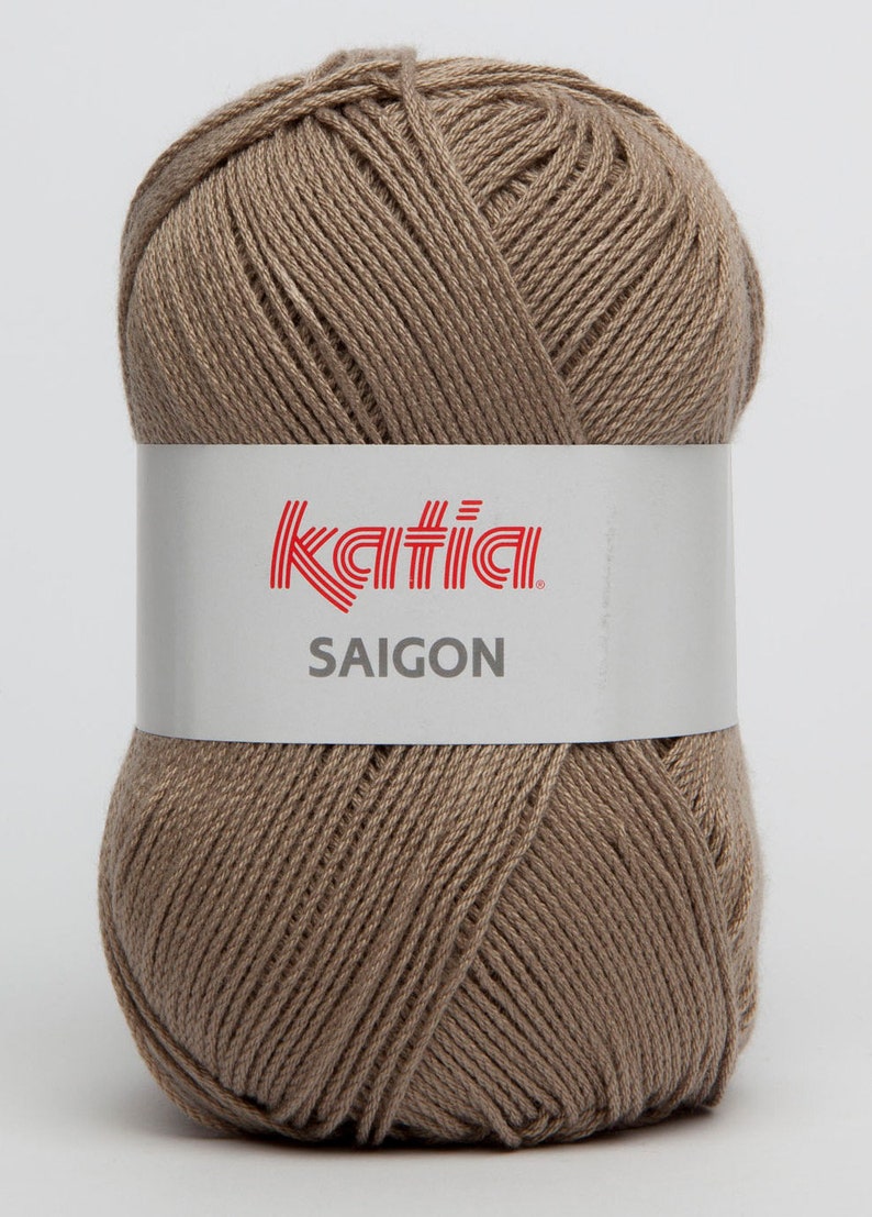 May include: A ball of Katia Saigon yarn in a light brown color. The yarn is made of 100% cotton and is suitable for knitting and crocheting.