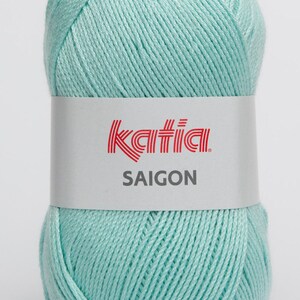 May include: A ball of light blue yarn with a white label that says "Katia SAIGON".
