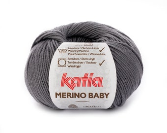 May include: A skein of gray wool yarn labeled "Katia Merino Baby" with washing and drying instructions.