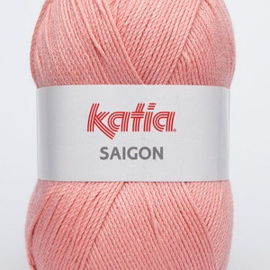 May include: A ball of pale pink yarn with the Katia brand label and the text "SAIGON" on it.