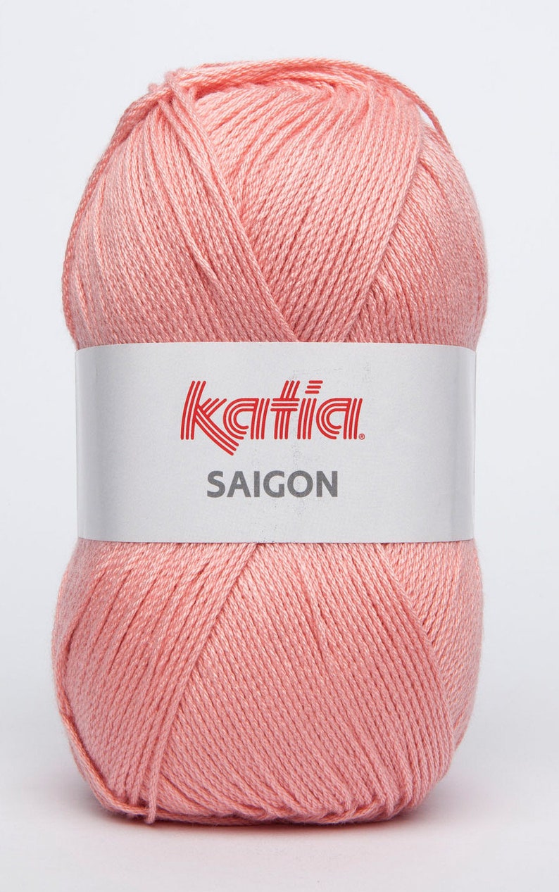 May include: A ball of pale pink yarn with the Katia brand label and the text "SAIGON" on it.
