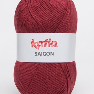 May include: A ball of deep red yarn with the label "Katia SAIGON" on it.