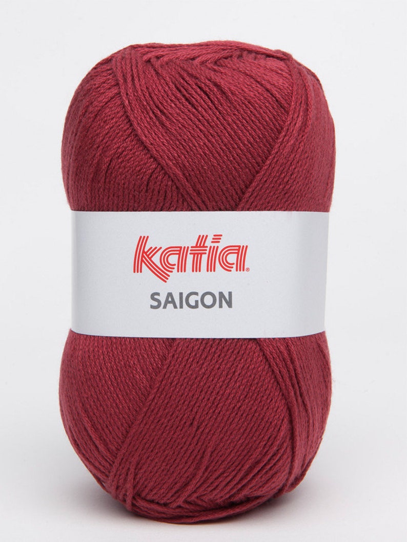 May include: A ball of deep red yarn with the label "Katia SAIGON" on it.