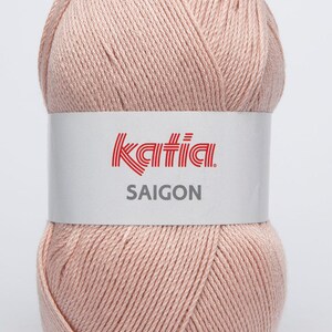 May include: A ball of pale pink yarn with a white label that reads "Katia SAIGON".