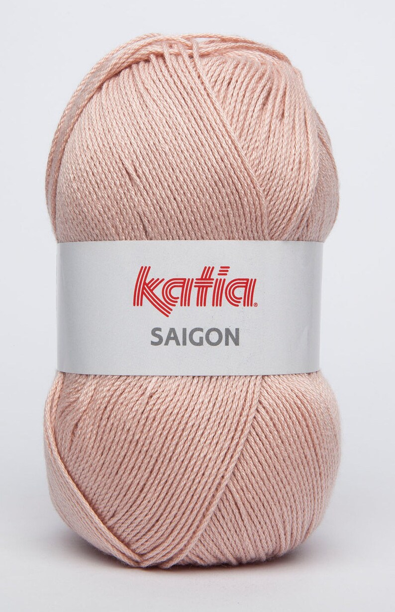 May include: A ball of pale pink yarn with a white label that reads "Katia SAIGON".