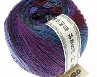 May include: A skein of purple, blue, and red yarn with a white label that says "Noro" and has Japanese text. The yarn is made in Japan.