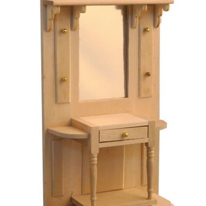 May include: Unfinished wooden wall mounted hall tree with a mirror, shelf, and a small drawer. The hall tree has a rounded base and decorative trim.