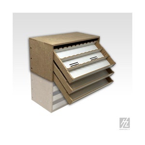 May include: A wooden storage cabinet with three pull-out drawers. Each drawer has multiple compartments for organising small items. The cabinet is made of light brown wood and has a white interior.