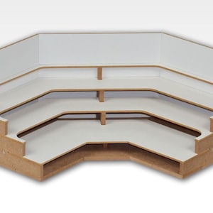 May include: A three-tiered corner shelf unit made of wood with white shelves. The unit has a hexagonal shape and is ideal for displaying small items.