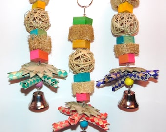 May include: Three colorful bird toys with bells, woven balls, and wood blocks. Each toy is strung together with natural fibers and has a metal hook for hanging.