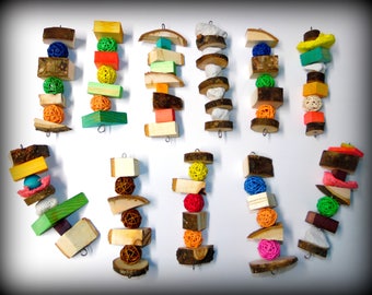 May include: A set of 14 colorful wooden bird toys, each with a different combination of wood pieces, balls, and other shapes. The toys are designed to be hung from a cage or play stand.
