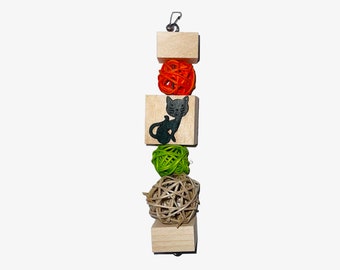 May include: A wooden cat toy with a black cat silhouette, a green, orange, and natural colored woven ball, and a wooden ring at the top with a metal hook.
