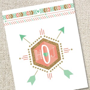 May include: A white printable card with a peach-coloured hexagon with gold glitter and the letters "HOJ" inside. The hexagon is surrounded by four green arrows with white tips. The top of the card has a border of peach, green, and gold geometric shapes.