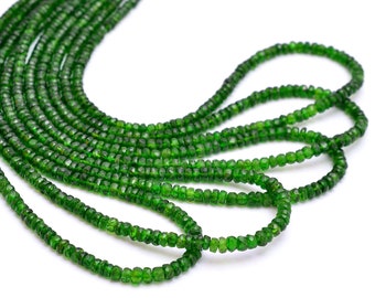 May include: A strand of green gemstone beads, likely peridot, arranged in a loose, flowing pattern. The beads are faceted and have a slightly irregular shape, giving them a unique and natural look.