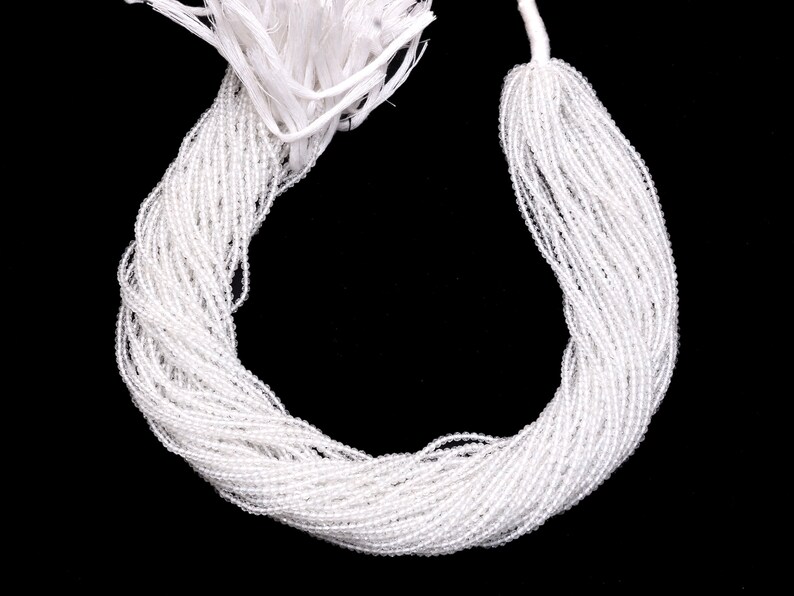 May include: A strand of white glass beads, perfect for jewelry making or crafting projects.