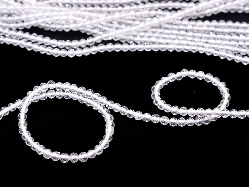 May include: A strand of clear crystal beads, with a smaller strand of the same beads forming a circle.