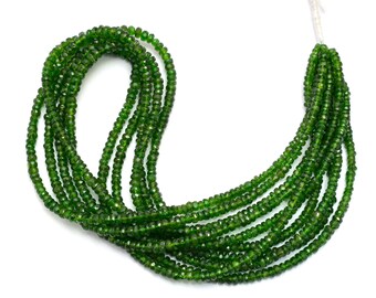 May include: A strand of green gemstone beads, likely peridot or green aventurine, with a faceted finish. The beads are strung on a white thread and are approximately 3mm in diameter.