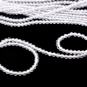 May include: A strand of clear crystal beads, with a smaller strand of the same beads forming a circle.