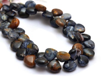 May include: A strand of blue, brown, and black gemstone beads in a heart shape. The beads are strung on a clear string and are ready to be used for jewelry making.