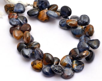 May include: A strand of blue and brown tiger's eye gemstone beads in a heart shape. The beads are strung on a white cord.