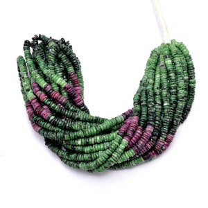 May include: A strand of green and pink gemstone beads. The beads are round and have a smooth, polished finish.
