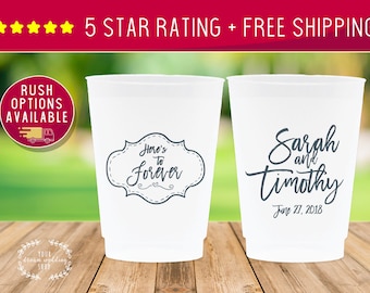May include: Two white plastic cups with black text. One cup says "Here's to Forever" in a decorative frame. The other cup says "Sarah and Timothy" with the date "June 27, 2018".