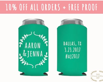 May include: Two green and white personalized can coolers. One cooler has the names "Aaron & Jenna" with a floral wreath design. The other cooler has the text "Dallas, TX 3.23.2017 #AJ2017".