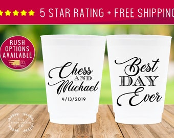 May include: Two white plastic cups with black text. One cup says "Chess and Michael 4/13/2019". The other cup says "Best Day Ever".