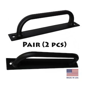 May include: A pair of black metal door handles with a curved design. The handles are made in the USA. PAIR (2 PCS)