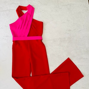 May include: A red jumpsuit with a pink halter top and a wide, black waistband.