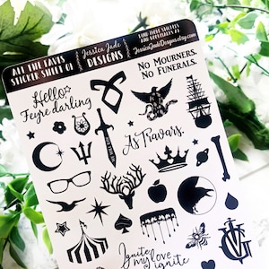 May include: A sticker sheet featuring black and white illustrations of characters and symbols from the book A Court of Thorns and Roses. The sheet includes the text "Hello Feyre darling", "No Mourners. No Funerals." and "As Travars."